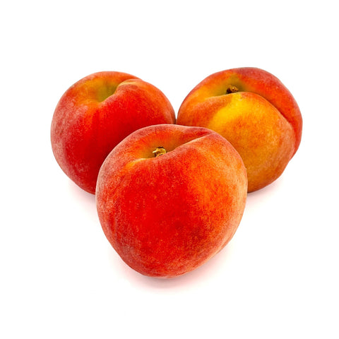 Fresh, sun-kissed peaches from 4Roots Farm Campus, nestled in a wooden crate with their soft blush skin glowing in natural light.