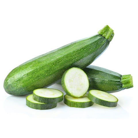Freshly harvested green zucchinis from 4Roots Farm Campus, stacked in a crate with their smooth skin glistening in the sun.