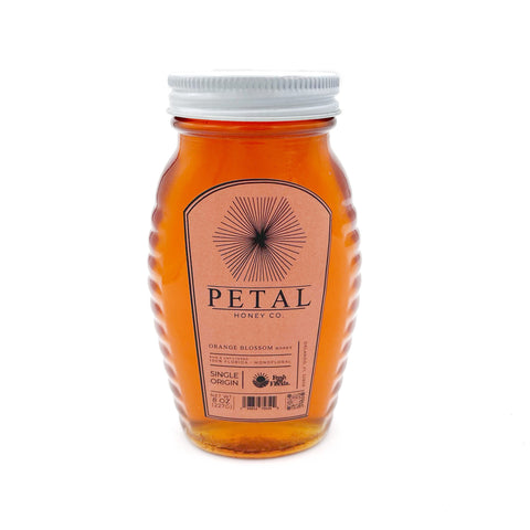 Jar of raw Orange Blossom Honey from Florida, 100% pure and unfiltered, harvested from orange grove blossoms, delicate floral and citrusy flavor, organic and sustainable honey perfect for pancakes, tea, and recipes