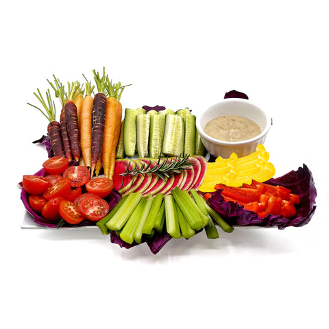 Fresh rainbow carrots, bell peppers, cucumbers, and celery in a farm-to-table crudité box