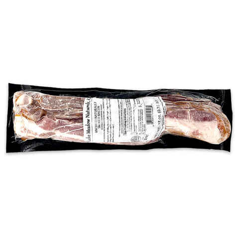 Package of Lake Meadow Naturals pasture-raised, thick-cut bacon, known for its rich flavor and high-quality, humane farming practices. Perfect for breakfast or cooking, sourced from locally raised pigs.