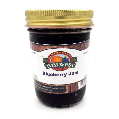 A jar of Tom West Blueberry Jam, packed with the bold, sweet flavor of farm-fresh blueberries. Smooth, spreadable, and perfect for toast, pastries, and more. Enjoy homemade-quality jam with every bite!