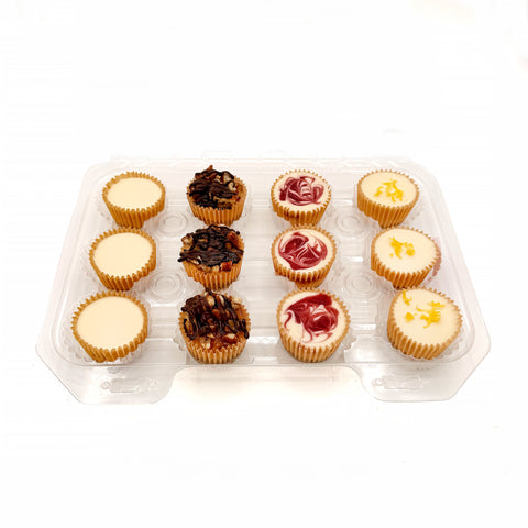 Assorted Sweet Owl cheesecake bites featuring Classic, Berry Swirl, Chocolate, and Lemon mini cheesecakes arranged in a dozen assortment box.