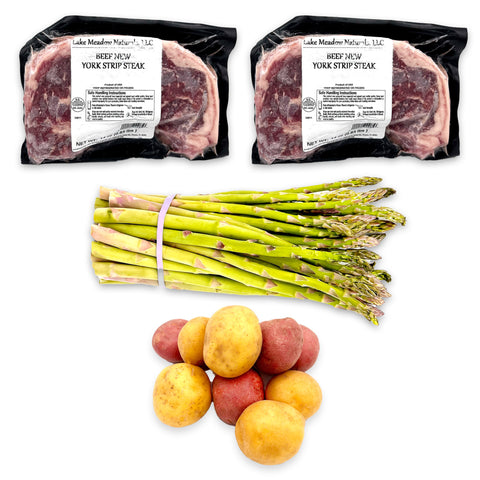 Steak Dinner for Two Ingredients – Includes 2 premium Lake Meadow Naturals NY Strip Steaks, 2 lbs of farm-fresh baby potatoes, 1 bunch of crisp asparagus, 1/2 stick of rich Amish butter, and a bundle of fresh herbs. Everything you need for a perfect homemade gourmet meal!