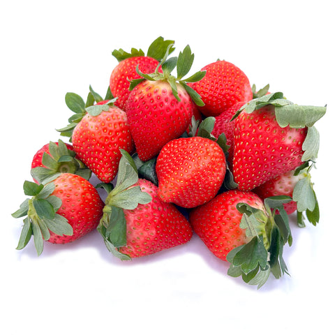 A pile of fresh organic strawberries on a white background, vibrant red with green leaves, showcasing their juicy, farm-fresh quality.