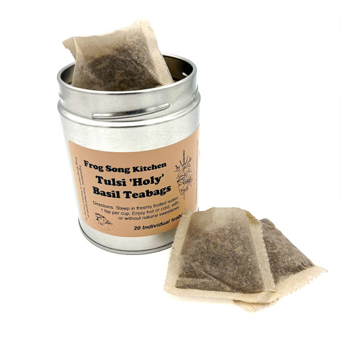 Tulsi 'Holy' Basil Teabags displayed in front of the metallic container, offering an organic, plant-based herbal tea perfect for calming and wellness.