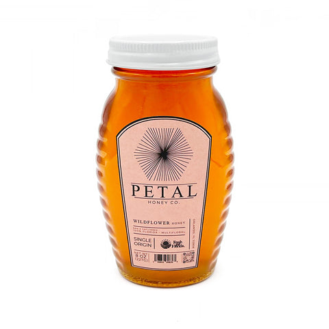 Petal Honey Co wildflower honey in an 8 oz glass jar, raw, organic, and pure, featuring a golden amber color and natural texture